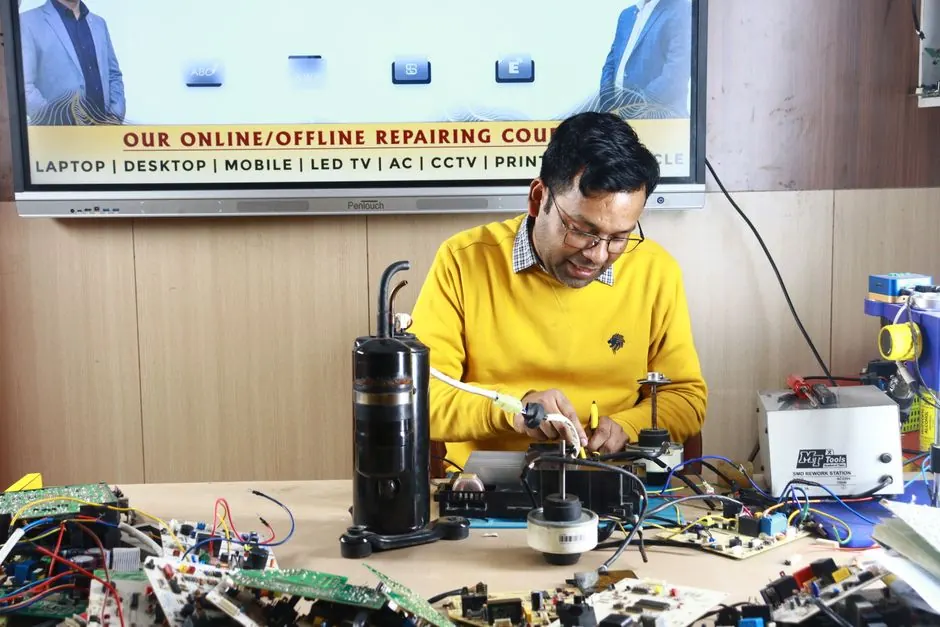 Technician engaged in AC repair at a New Delhi workshop. Indoor learning session.